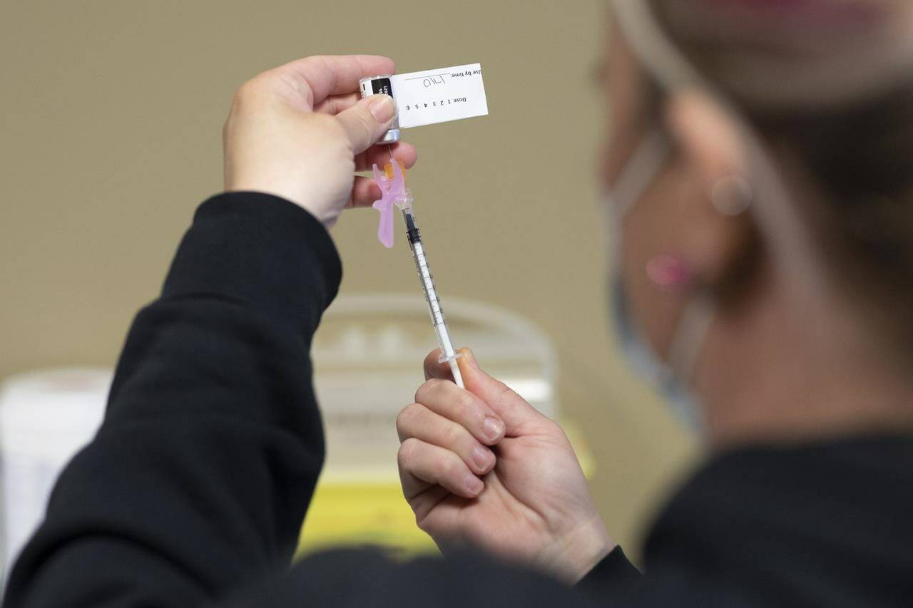A nurse draws the vaccine into a syringe at the Saskatoon Tribal Council run vaccination clinic inside SaskTel centre in Saskatoon, Sask., on Thursday, April 15, 2021. Saskatchewan has lifted its public health order that required residents to show a proof of COVID-19 vaccination or negative test to enter most businesses. THE CANADIAN PRESS/Kayle Neis
