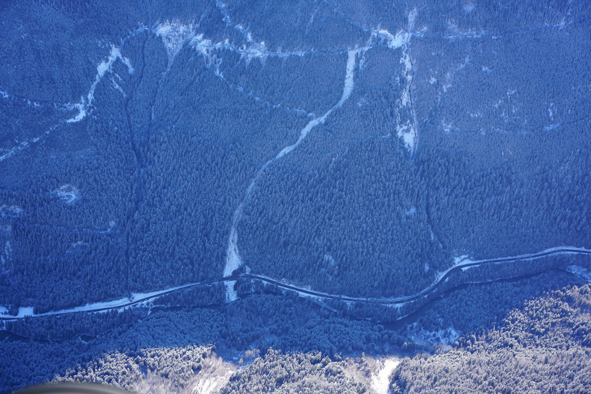 This photo from Conny Amelunxen, a snow avalanche forecaster and photographer, was taken Nov. 19, 2021, four days after the landslide that destroyed a portion of Highway 99, also called the Duffey Lake Road, and claimed the lives of five people. The landslide, at the right, can be seen leaving the logging road and heading down to Highway 99. (Contributed)