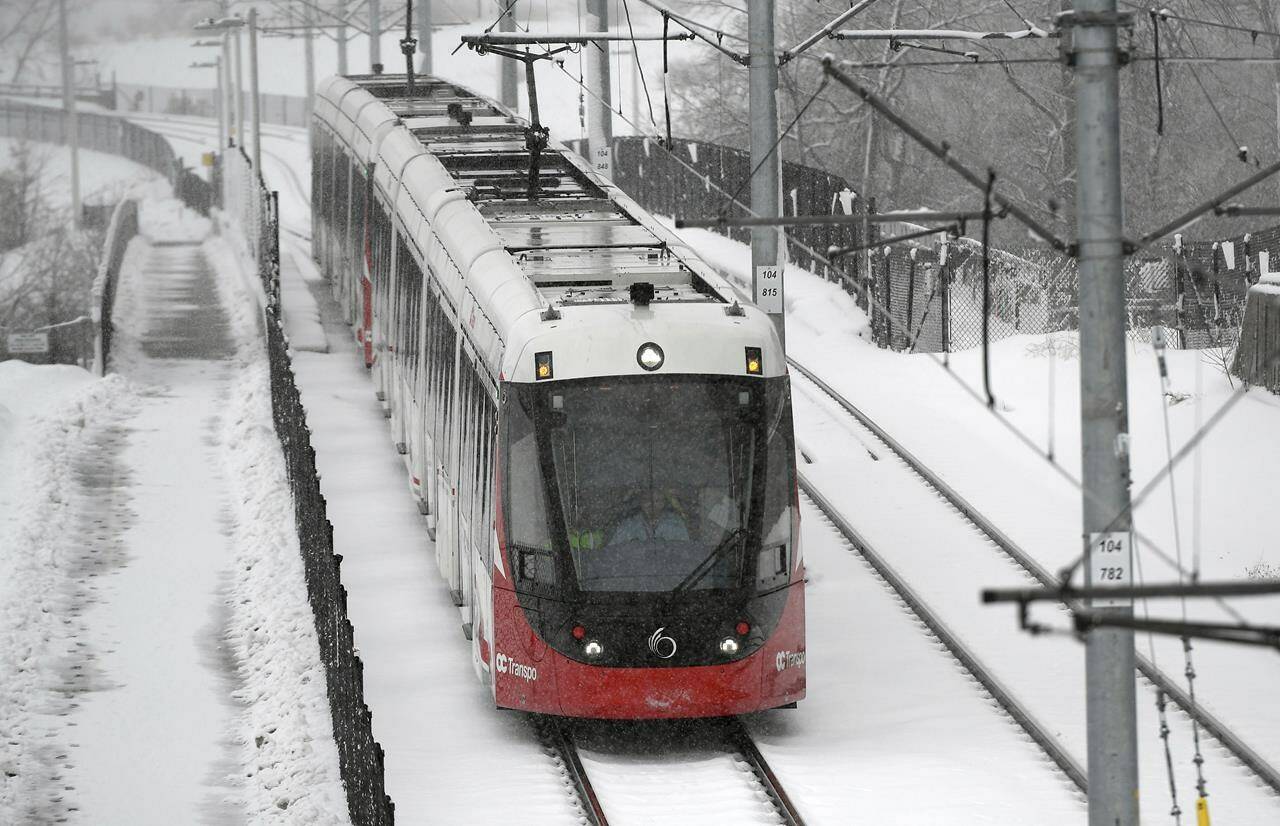 An OC Transpo LRT train heads towards Lees Station on the Confederation Line during a snowstorm in Ottawa, Thursday, Feb. 27, 2020. THE CANADIAN PRESS/Justin Tang