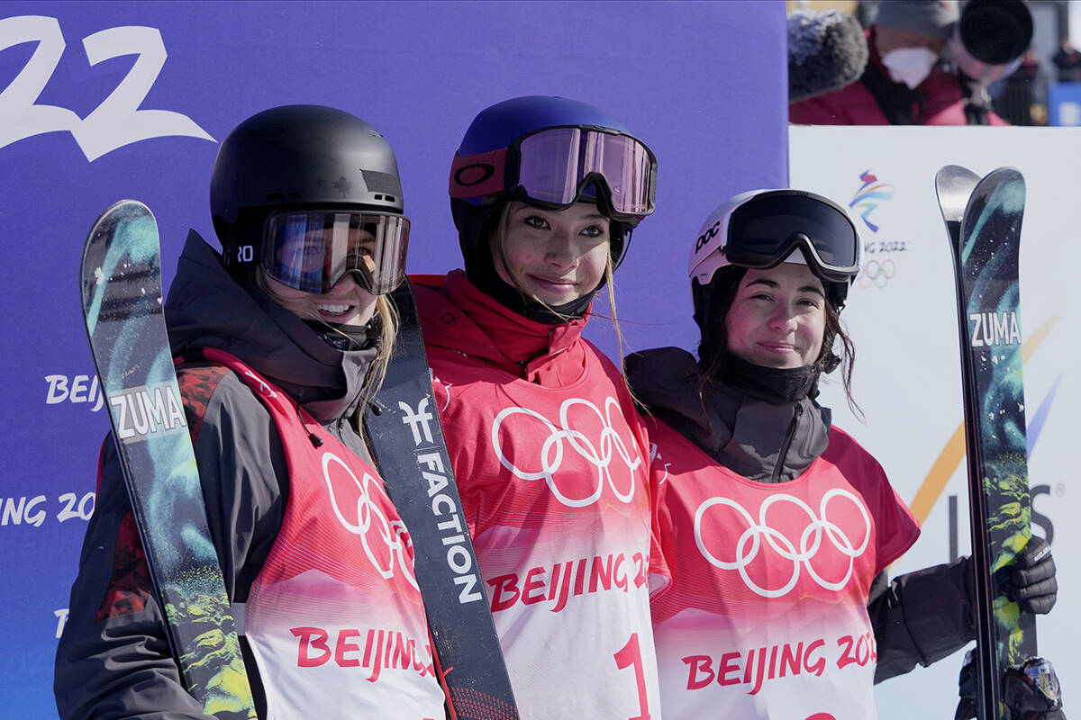 From left silver medal winner Canada’s Cassie Sharpe, gold medal winner China’s Eileen Gu and bronze medal winner Canada’s Rachael Karker celebrate after the women’s halfpipe finals at the 2022 Winter Olympics, Friday, Feb. 18, 2022, in Zhangjiakou, China. (AP Photo/Lee Jin-man)