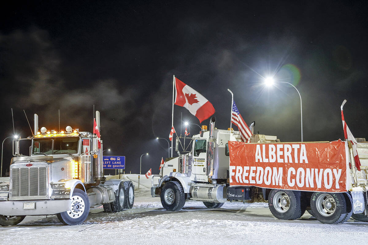 Anti-COVID-19 vaccine mandate demonstrators gather as a truck convoy blocks the highway at the busy U.S. border crossing in Coutts, Alta., Tuesday, Feb. 1, 2022.THE CANADIAN PRESS/Jeff McIntosh