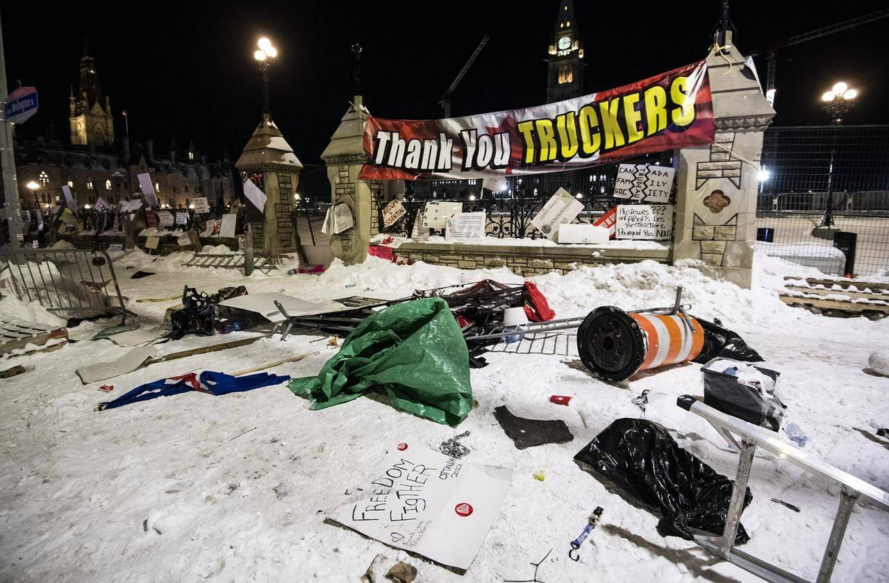Debris lays on the ground in front of Parliament Hill’s gates after police took action to clear the street of trucks and protesters to end a protest, which started in opposition to mandatory COVID-19 vaccine mandates and grew into a broader anti-government demonstration and occupation, on its 23rd day, in Ottawa, Saturday, Feb. 19, 2022. Being able to designate no-go zones, ensure tow trucks were available to remove vehicles and stop the flow of money and goods keeping the demonstrators fed and fuelled are all clear reasons the Emergencies Act was needed to end the Ottawa blockades, Public Safety Minister Marco Mendicino said. THE CANADIAN PRESS/Justin Tang