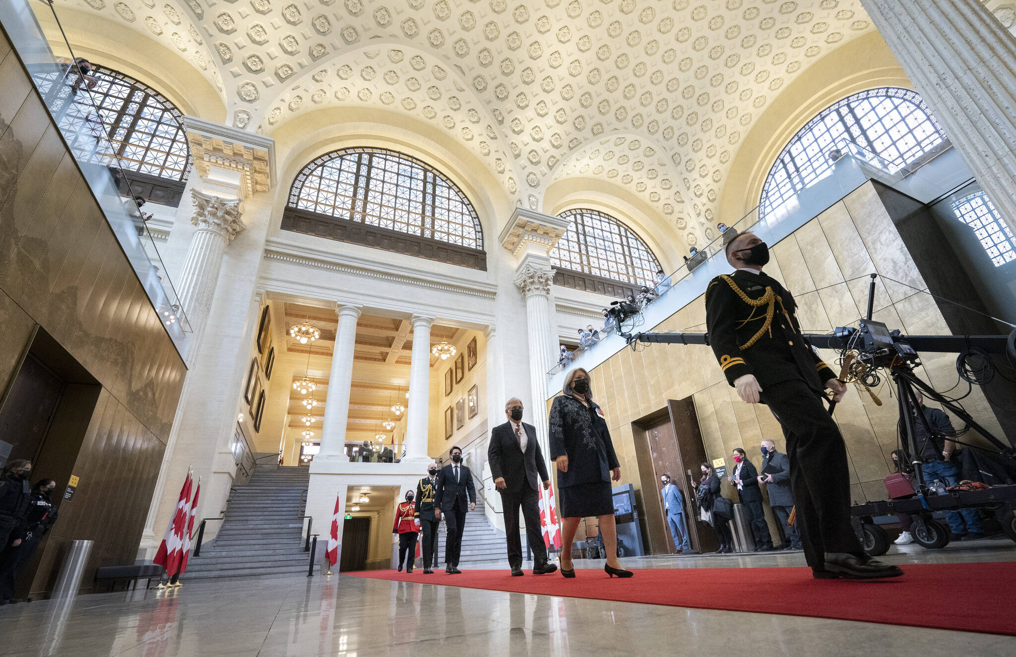 Gov. Gen. Mary Simon walks with her husband Whit Fraser, and Prime Minister Justin Trudeau through the foyer of the Senate of Canada building before delivering the Speech from the Throne in Ottawa, on Tuesday, Nov. 23, 2021. THE CANADIAN PRESS/Justin Tang