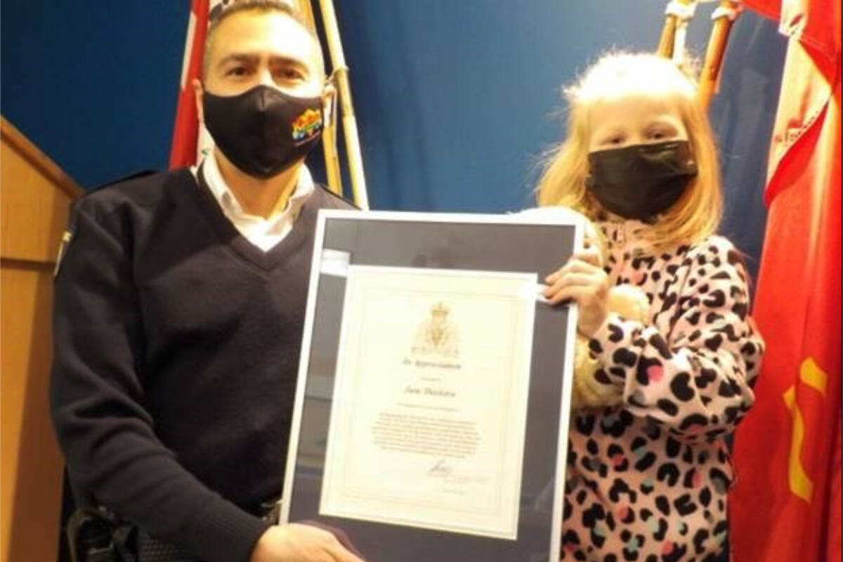 Kamloops RCMP Supt. Sydney Lecky presents six-year-old Jane Deelstra with a Kamloops RCMP Certificate of Appreciation in recognition of the bravery she displayed after her grandmother’s vehicle crashed near Dallas Drive on Feb. 19. (Kamloops RCMP photo)