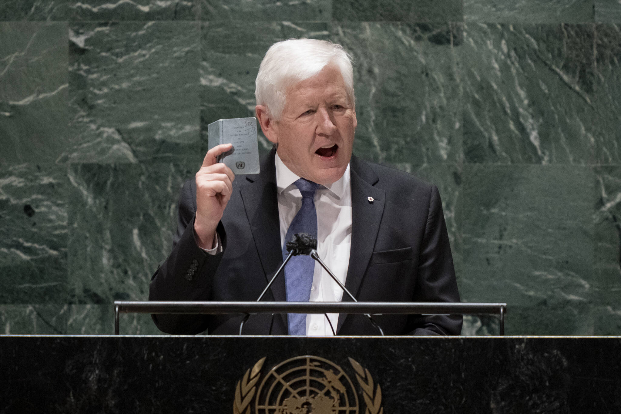 Bob Rae, ambassador of Canada to the United Nations, speaks while holding a copy of the United Nations charter at the general assembly hall, Wednesday, Feb. 23, 2022, at United Nations Headquarters. Russian President Vladimir Putin has received no support from members of the U.N. Security Council for his actions to bring separatists in eastern Ukraine under Moscow’s control. At an emergency meeting Monday night, the U.S. called Putin’s moves a pretext for a further invasion. (AP Photo/John Minchillo)