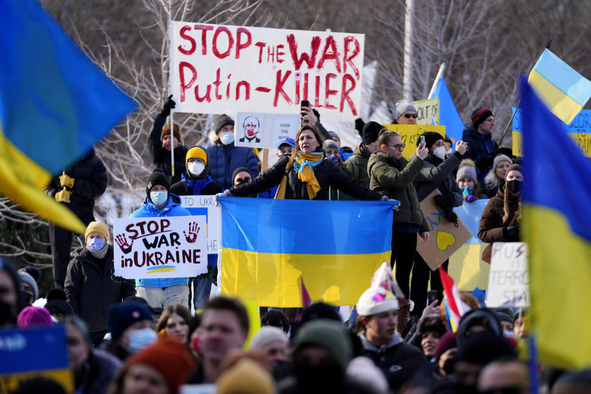 People rally against Russia’s invasion of Ukraine during a protest outside City Hall in Ottawa, on Sunday, Feb. 27, 2022. THE CANADIAN PRESS/Justin Tang