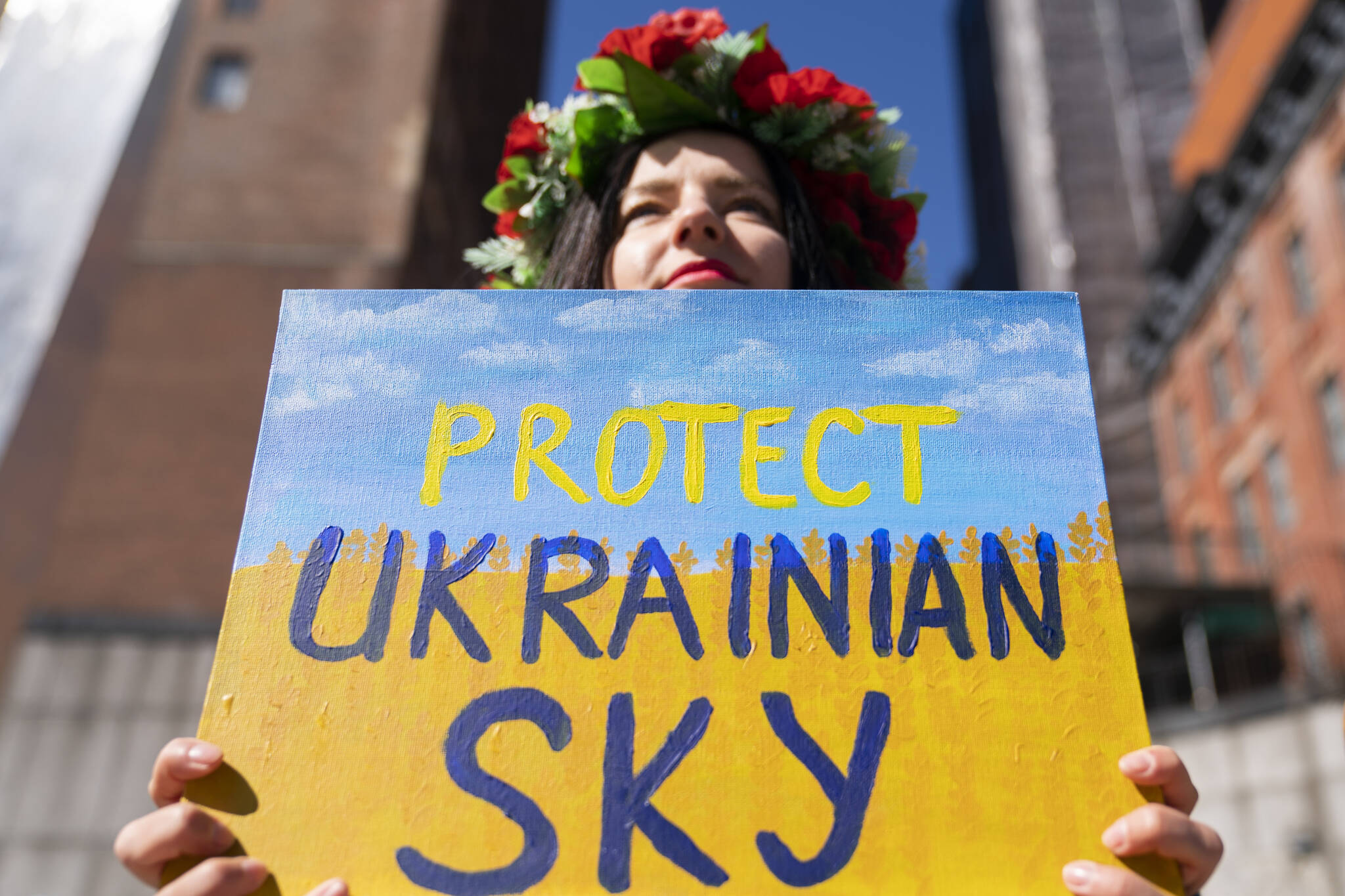 Protesters supporting Ukraine gather outside the United Nations during an emergency meeting of the UN General Assembly, Monday, Feb. 28, 2022, in New York. The U.N.’s two major bodies, the 193-nation General Assembly and the more powerful 15-member Security Council, are holding separate meetings Monday on Russia’s invasion of Ukraine. (AP Photo/John Minchillo)