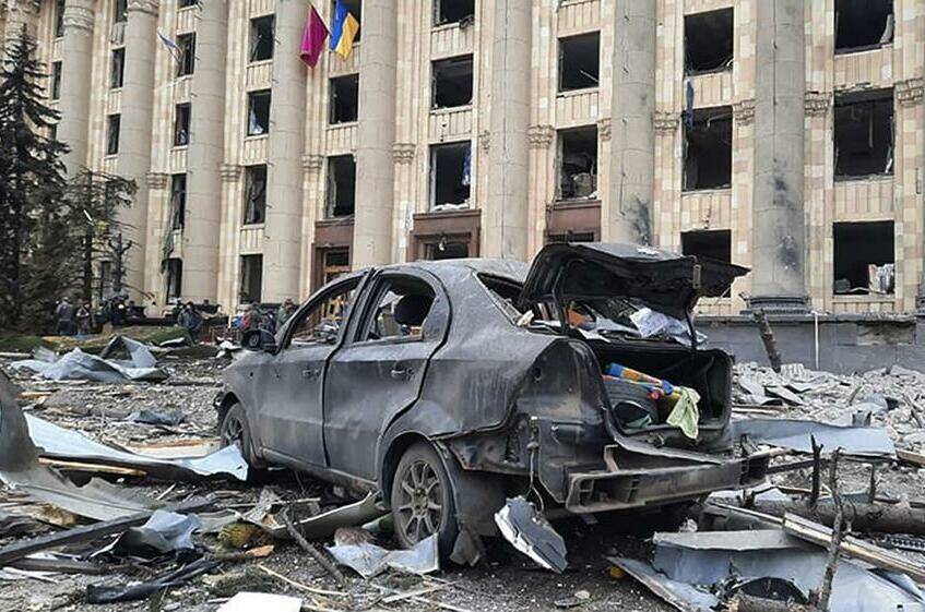 In this handout photo released by Ukrainian Emergency Service, a burnt car is seen in front of a damaged City Hall building, in Kharkiv, Ukraine, Tuesday, March 1, 2022. Russian shelling pounded civilian targets in Ukraine’s second-largest city, Kharkiv, Tuesday and a 40-mile convoy of tanks and other vehicles threatened the capital - tactics Ukraine’s embattled president said were designed to force him into concessions in Europe’s largest ground war in generations. (Ukrainian Emergency Service via AP)