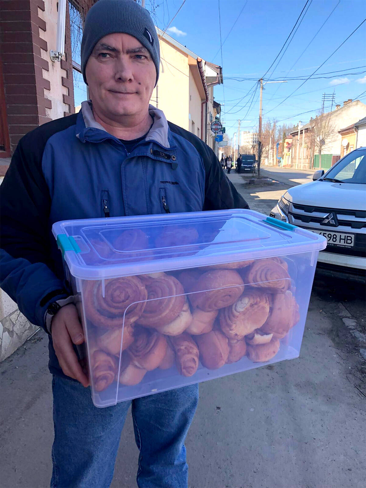 Mark Friesen carries baking to hand out in his town in western Ukraine. (Submitted photo)