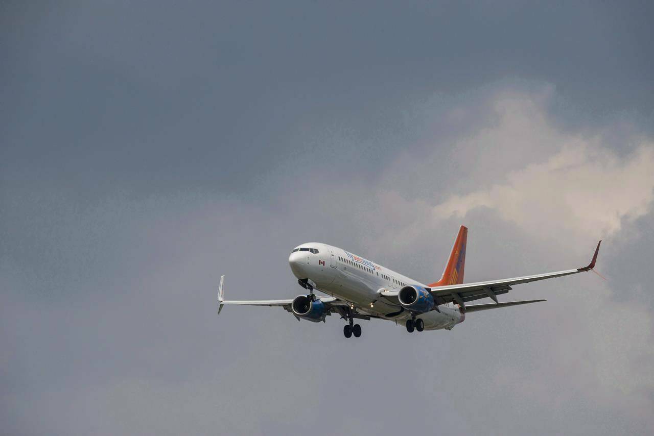 A Sunwing Boeing 737-800 passenger plane prepares to land at Pearson International Airport in Toronto on Wednesday, August 2, 2017. THE CANADIAN PRESS/Christopher Katsarov