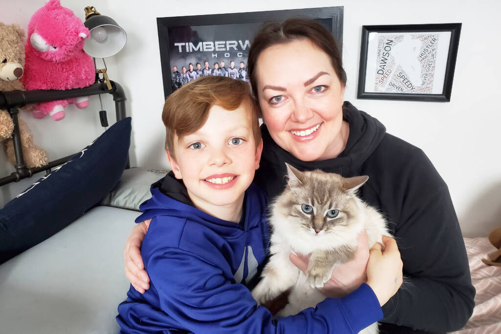 Sutter, 9, and his mom Leslie Rowse, hold Hazel the cat. When the Williams Lake BSCPCA asked for help to pay for Hazel’s surgery, the son and mom duo held a bake sale and raised $850. Now they’ve adopted Hazel. (Monica Lamb-Yorski photo - Williams Lake Tribune)