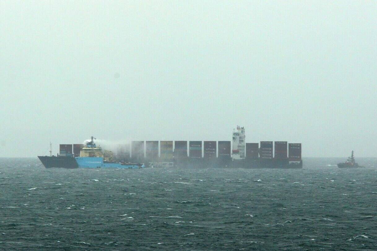 Ships work to control a fire onboard the MV Zim Kingston about eight kilometres from the shore in Victoria, B.C., on Monday, October 25, 2021. A volunteer organization that has been cleaning up debris from the cargo ship that lost 109 containers off the B.C. coast last fall says the incident should be a wake-up call to the need for more urgent action.THE CANADIAN PRESS/Chad Hipolito