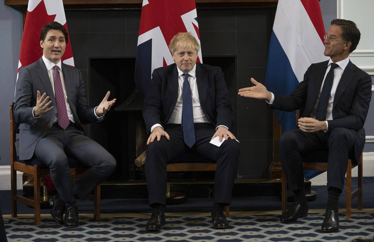 British Prime Minister Boris Johnson looks on as Prime Minister of the Netherlands Mark Rutte gestures to Canadian Prime Minister Justin Trudeau, Monday, March 7, 2022 at Royal Air Force station Northholt. THE CANADIAN PRESS/Adrian Wyld