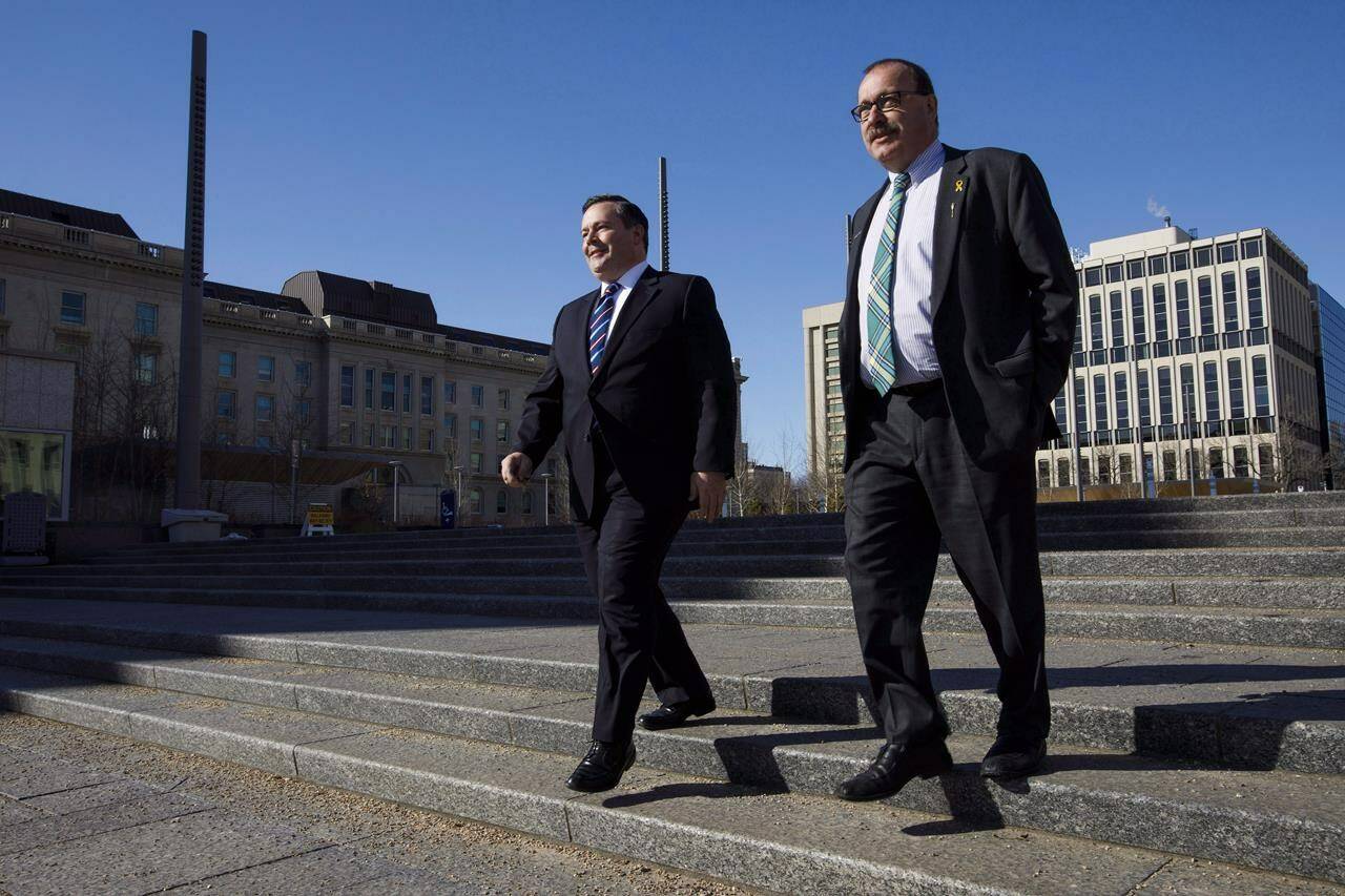 Alberta Progressive Conservative leader Jason Kenney, left, walks with Ric McIver at the Federal Building in Edmonton, Alta., on Monday, March 20, 2017. THE CANADIAN PRESS/Codie McLachlan