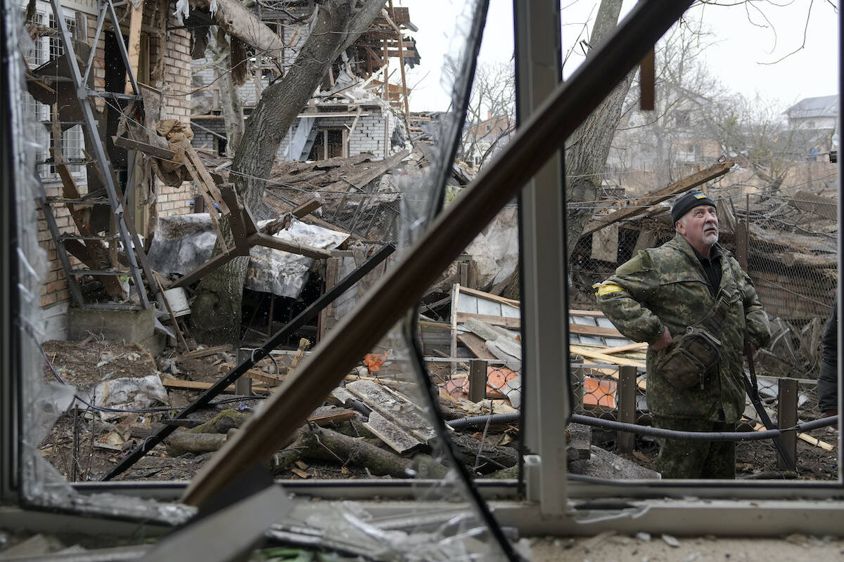 Andrey Goncharuk, 68, a member of the territorial defense stands in the backyard of a house damaged by a Russian airstrike, according to locals, in Gorenka, outside the capital Kyiv, Ukraine, Wednesday, March 2, 2022. Russia renewed its assault on Ukraine’s second-largest city in a pounding that lit up the skyline with balls of fire over populated areas, even as both sides said they were ready to resume talks aimed at stopping the new devastating war in Europe. (AP Photo/Vadim Ghirda)
