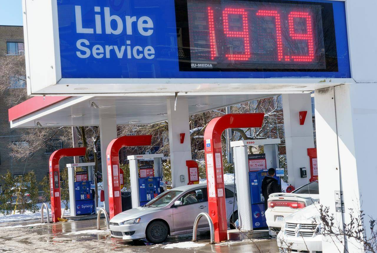 Motorists fill up at a gas station in Montreal on Tuesday, March 8, 2022. Gasoline costs across Canada are expected to keep rising Thursday, even after a significant mid-week dip in the price of oil. THE CANADIAN PRESS/Paul Chiasson