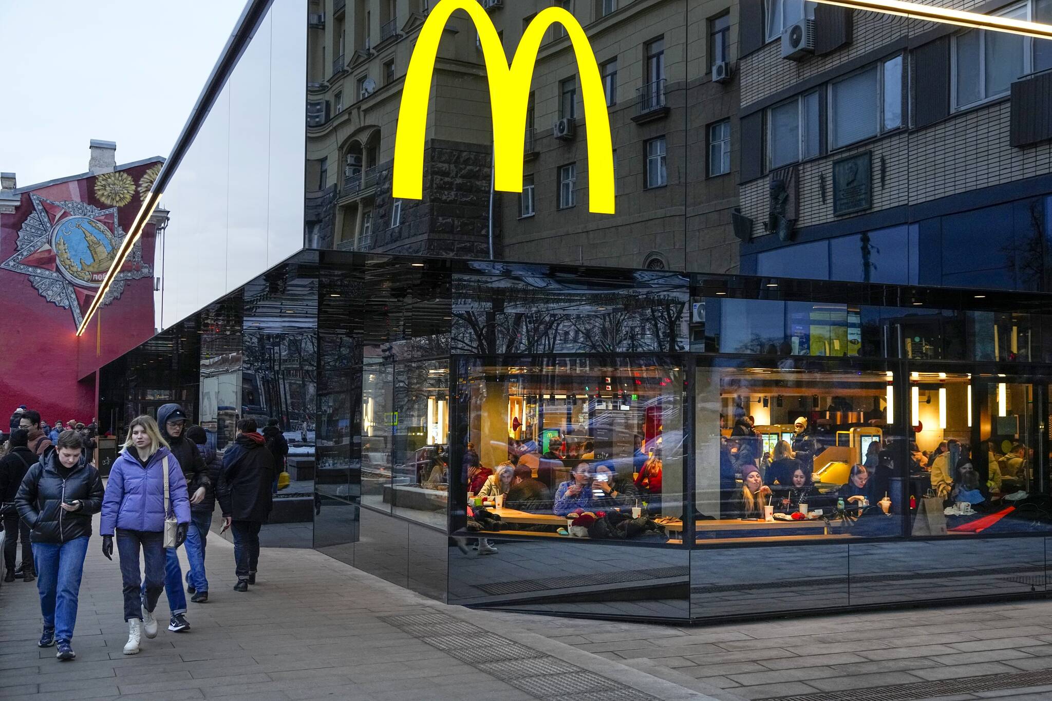 People eat in a McDonald’s restaurant in the main street in Moscow, Russia, Sunday, March 13, 2022. (AP Photo)