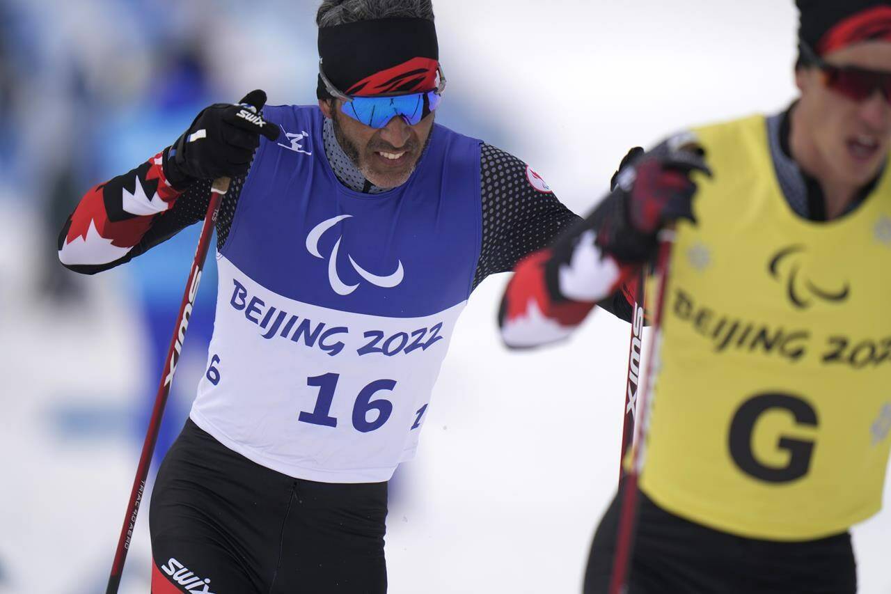 Canada’s Brian McKeever and his guide Graham Nishikawa compete during the men’s middle distance free technique vision impaired event of para cross country skiing at the 2022 Winter Paralympics, in Zhangjiakou, China, Saturday, March 12, 2022. McKeever is retiring after capturing 20 medals over six Games, many with brother Robin as his guide. THE CANADIAN PRESS/AP-Shuji Kajiyama