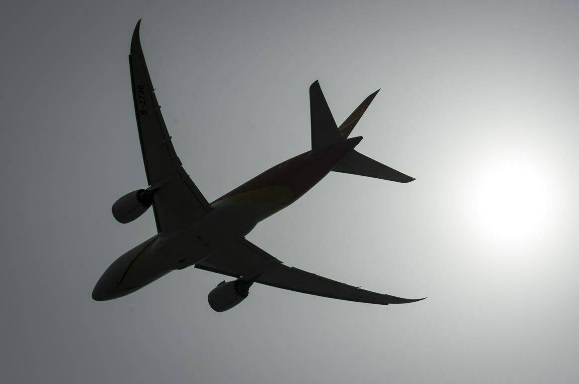 A plane is silhouetted as it takes off from Vancouver International Airport in Richmond, B.C., Monday, May 13, 2019. Airlines are facing a second headwind of skyrocketing oil prices — which could make airfares even more expensive.THE CANADIAN PRESS/Jonathan Hayward