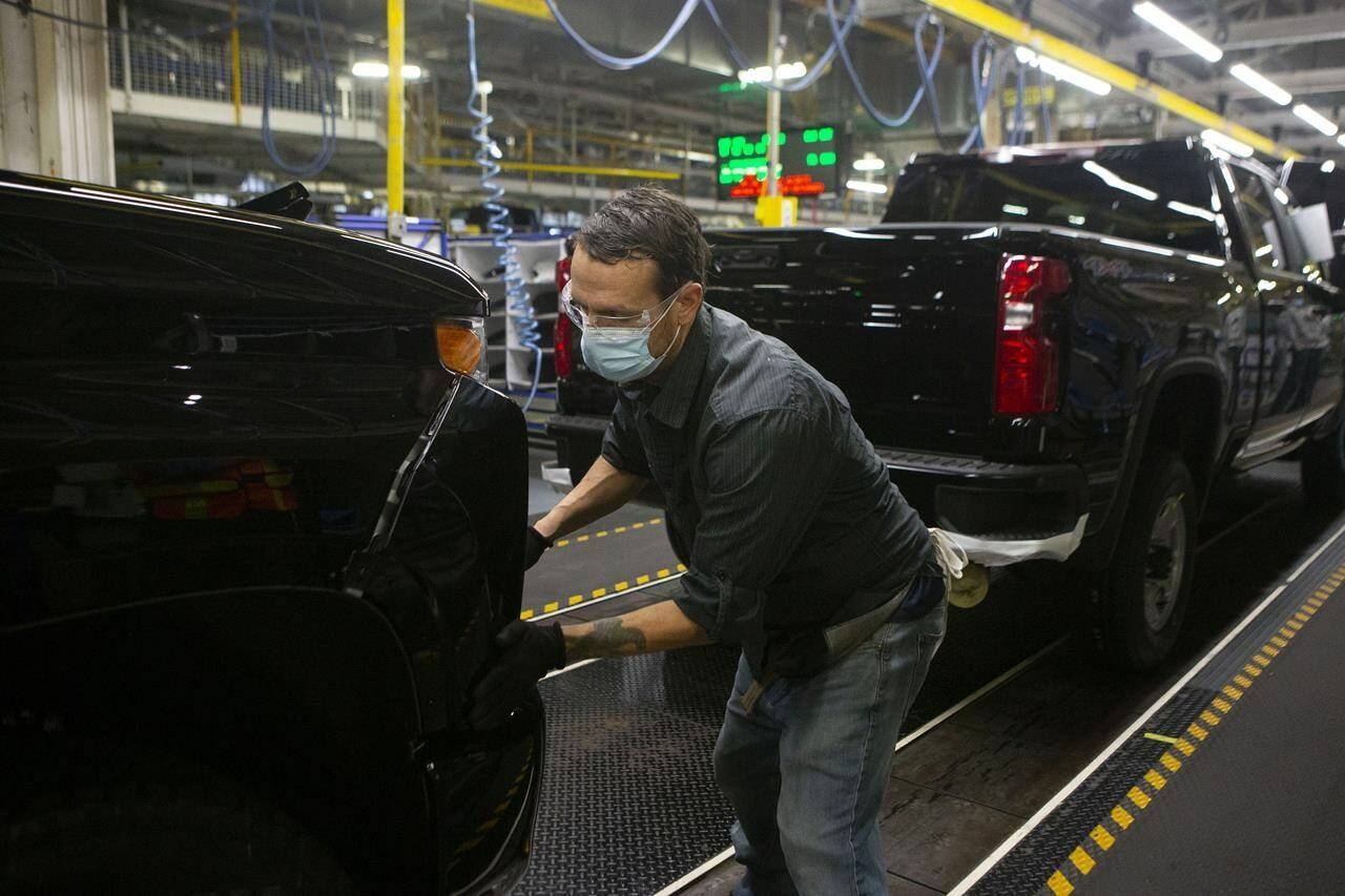 An autoworker is seen on the general assembly line producing the Chevrolet Silverado, at the General Motors plant in Oshawa, Ont., on Tuesday, Feb. 22 2022. THE CANADIAN PRESS/Chris Young