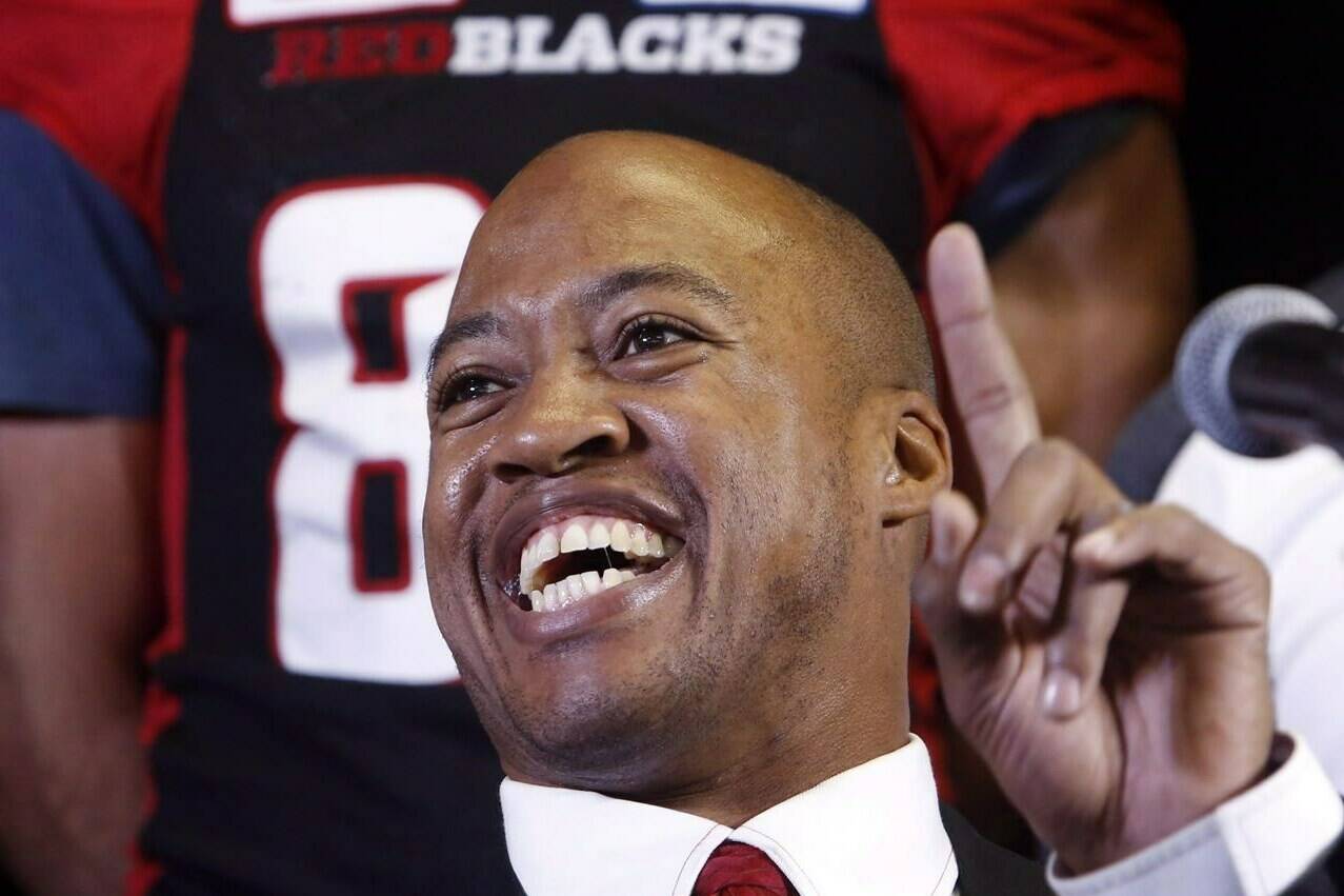 Ottawa Redblacks CFL football quarterback Henri Burris smiles as he announces his retirement in Ottawa Tuesday January 24, 2017. Burris joined the B.C. Lions coaching staff Tuesday as an offensive consultant.THE CANADIAN PRESS/Fred Chartrand