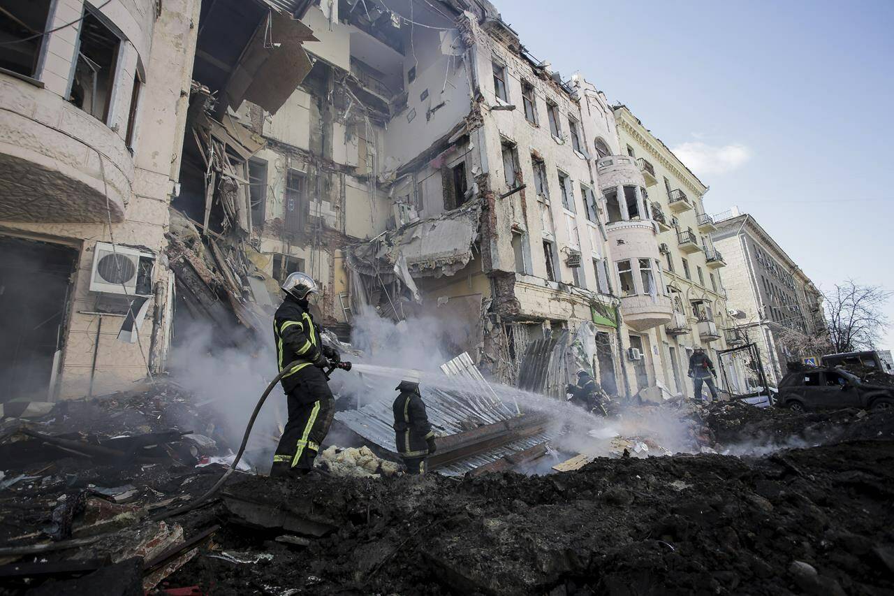 Firefighters extinguish an apartment house after a Russian rocket attack in Kharkiv, Ukraine’s second-largest city, Ukraine, Monday, March 14, 2022. A new poll suggests nearly three quarters of Canadians believe NATO allies should prepare for military intervention as Russian aggression escalates in Ukraine, even as half hold out hope for a diplomatic resolution. THE CANADIAN PRESS/AP-Pavel Dorogoy