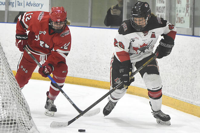 Okanagan Hockey Academy forward Sophie Lalor battling for the puck with a Pursuit of Excellence player during the female prep CSSHL championship in March 2018. Pursuit won the game 6-3. (Mark Brett/Western News)