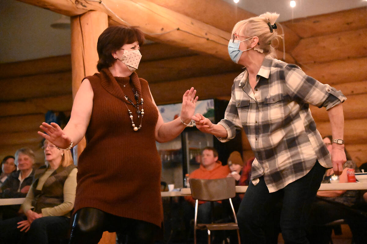 Shirley Frost, left, and Gerda Faber, both members of the Wells Gray Lively Arts Society, pick up their feet during a blues song performed by Randy Hedlund and Linda MacKenzie. A Coffee House was held by the WGLAS on Saturday, March 5 in the lodge at the Clearwater ski hill. It was the first Coffee House to be held since COVID-19 restrictions were eased last month. (Stephanie Hagenaars/Clearwater Times)