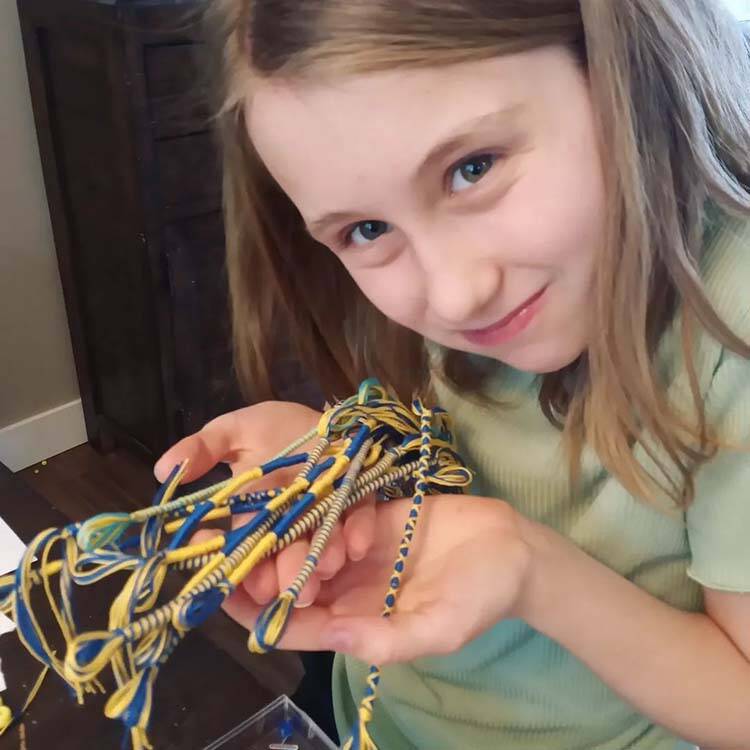 Hailey Townsend is making and selling yellow-and-blue bracelets to help raise money for Ukraine. (Submitted photo)