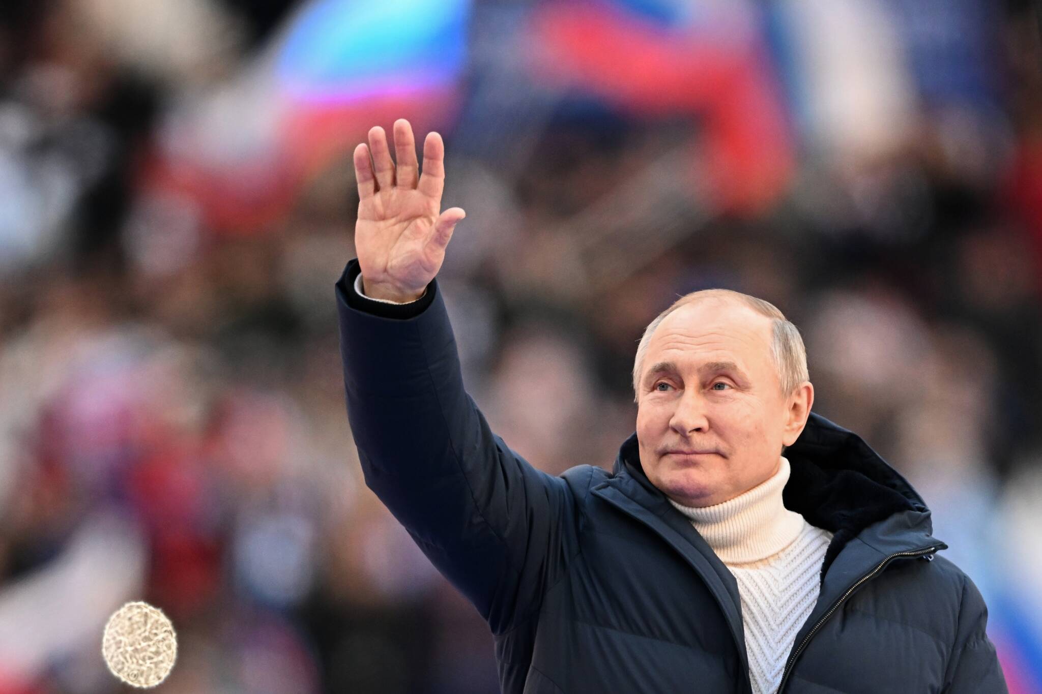 Russian President Vladimir Putin greets people gathered to attend the concert marking the eighth anniversary of the referendum on the state status of Crimea and Sevastopol and its reunification with Russia, in Moscow, Russia, Friday, March 18, 2022. (Ramil Sitdikov/Sputnik Pool Photo via AP)