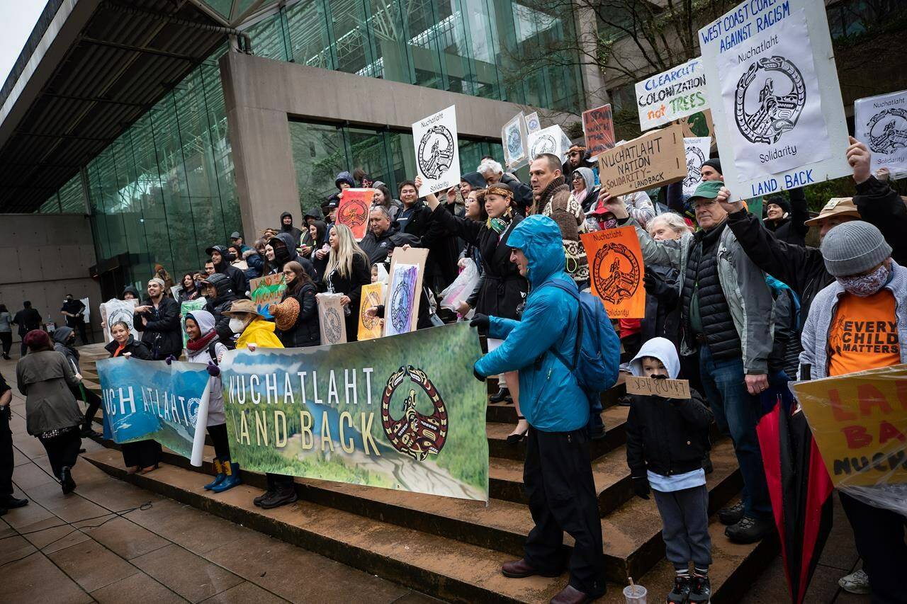 Members of the Nuchatlaht First Nation and supporters rally outside the B.C. Supreme Court before the start of an Indigenous land title case in Vancouver on Monday, March 21, 2022. The lawsuit brought by the First Nation against the provincial government seeks to reclaim part of its territory on Nootka Island. THE CANADIAN PRESS/Darryl Dyck