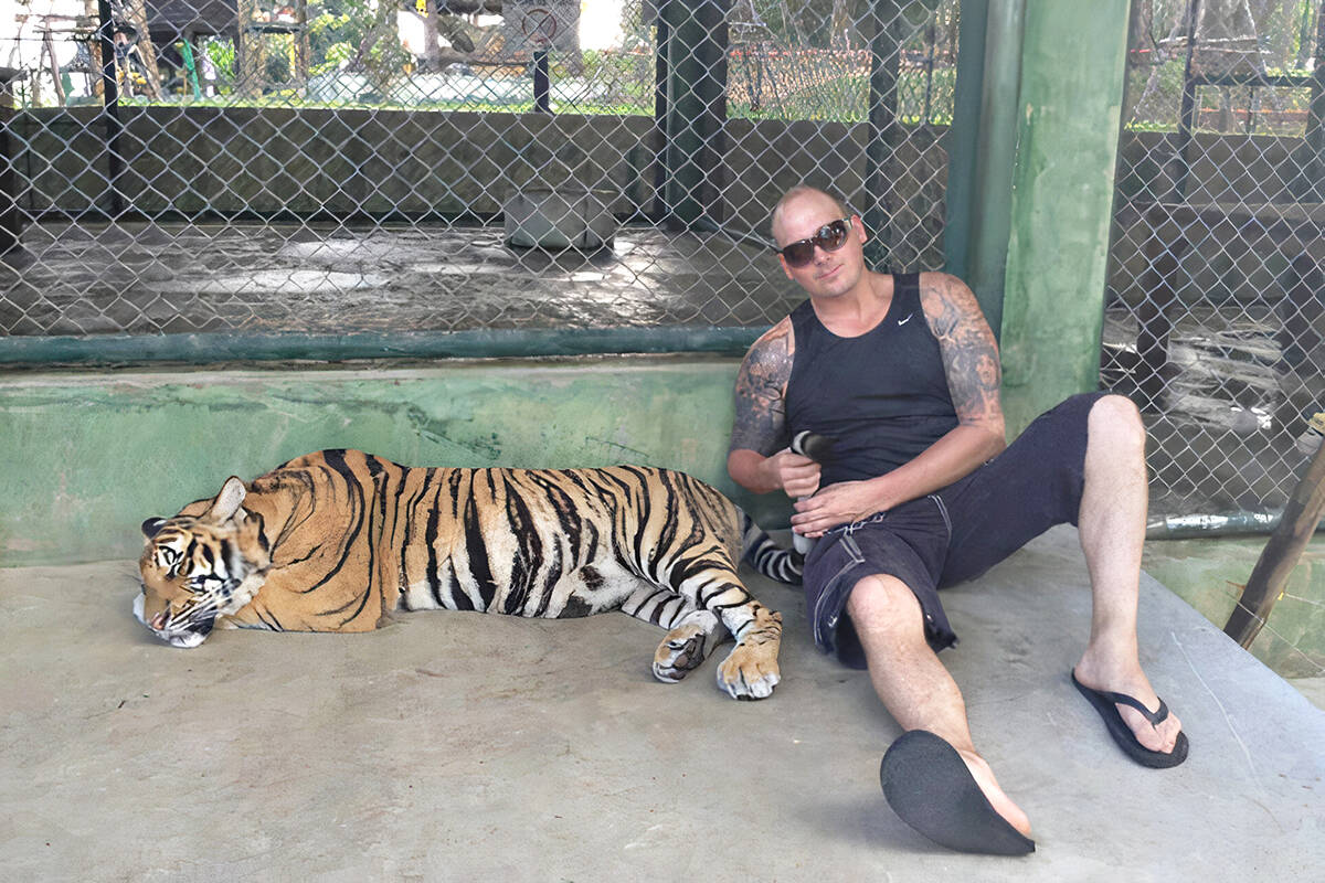 Clayton Eheler seen with a tiger somewhere in Asia in 2014. (file)