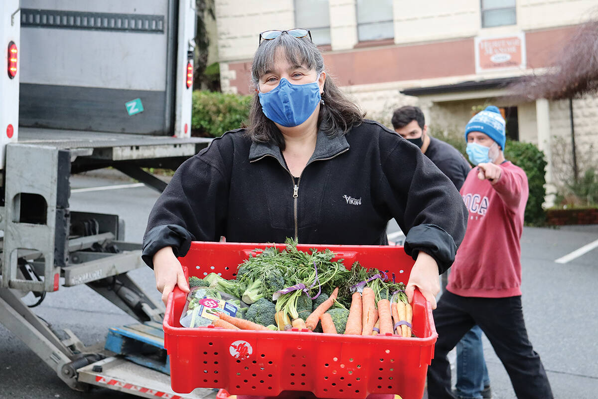 Non-profits, like the Ladysmith Resource Centre Association have faced a decline in revenue, higher operating costs, and a lack of volunteers throughout the pandemic. FILE: Ladysmith Food Bank coordinator Paula Masyk unloads a bin of donated produce to distribute to Ladysmith residents. (Black Press file photo)