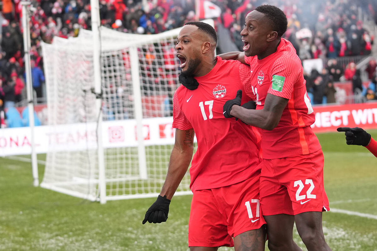 Canada’s Cyle Larin (17) celebrates his goal with Richie Laryea against Jamaica during first half CONCACAF World Cup soccer qualifying action in Toronto on Sunday, March 27, 2022. THE CANADIAN PRESS/Nathan Denette