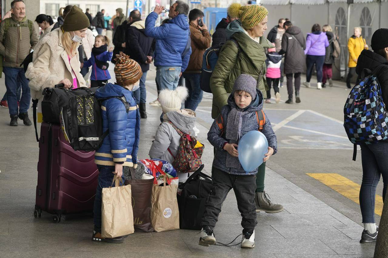 Ukrainian refugees wait for a transport at the central train station in Warsaw, Poland, Sunday, March 27, 2022. More than 3.7 million people have fled the war so far, Europe’s largest exodus since World War II. (AP Photo/Czarek Sokolowski)