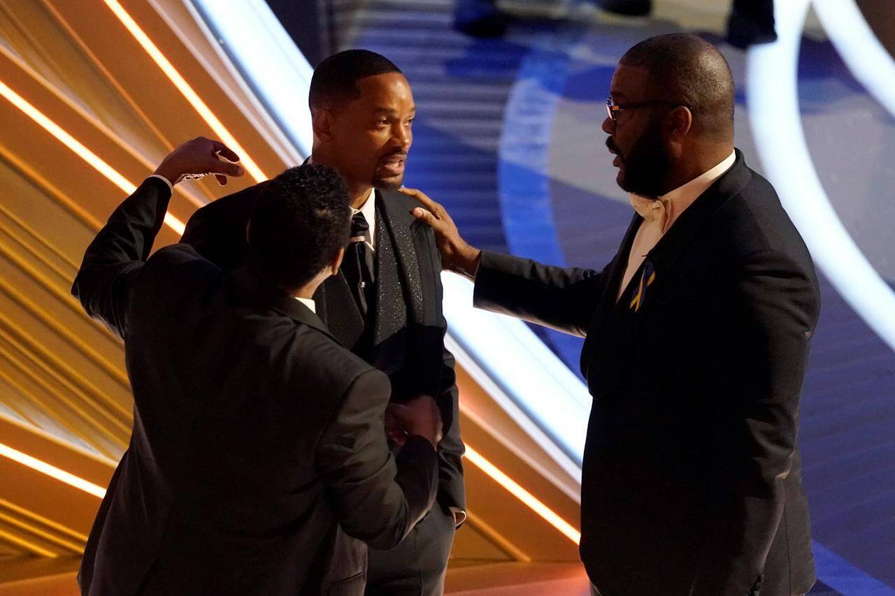 Sean Combs, from left, Will Smith and Tyler Perry appear in the audience at the Oscars on Sunday, March 27, 2022, at the Dolby Theatre in Los Angeles. (AP Photo/Chris Pizzello)