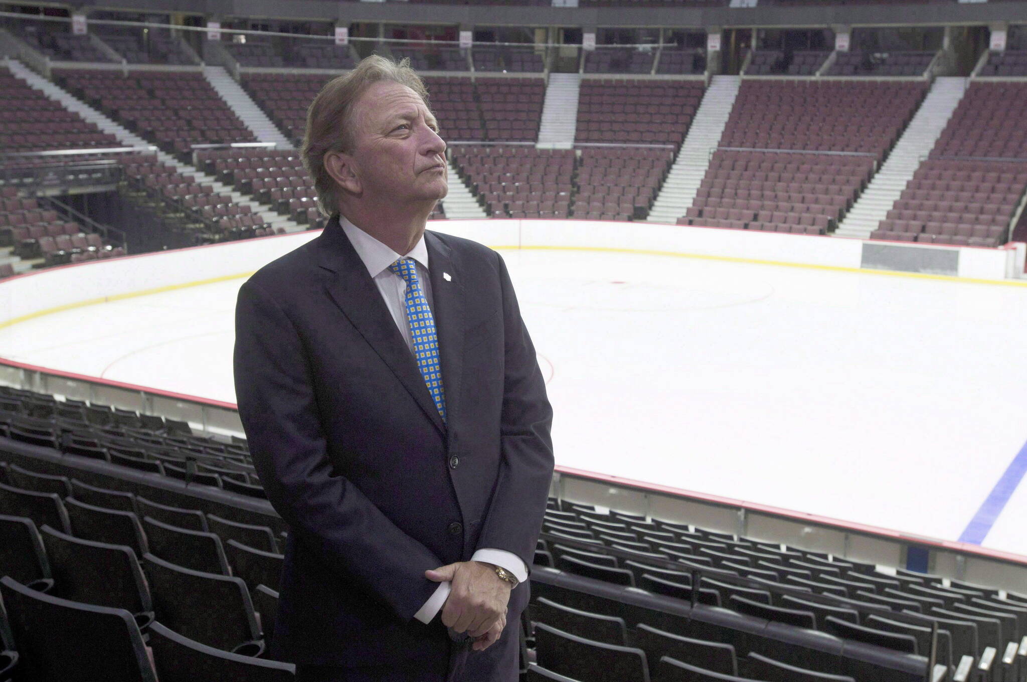 Ottawa Senators owner Eugene Melnyk stands near the ice as members of the media are given a tour of changes to the Canadian Tire Centre in Ottawa on September 7, 2017. Melnyk is suing his business partner for $700 million in a development deal that was meant to bring a new NHL arena to Ottawa’s downtown. THE CANADIAN PRESS/Adrian Wyld