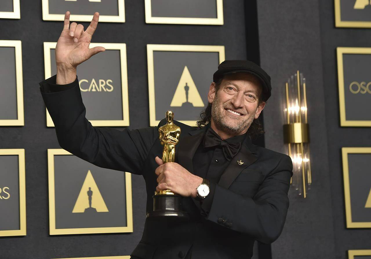 FILE - Troy Kotsur, winner of the award for best performance by an actor in a supporting role for “CODA,” poses in the press room at the Oscars on March 27, 2022, at the Dolby Theatre in Los Angeles. The three Oscar wins for the film “CODA” has provided an unprecedented feeling of affirmation to people in the Deaf community. (Photo by Jordan Strauss/Invision/AP, File)