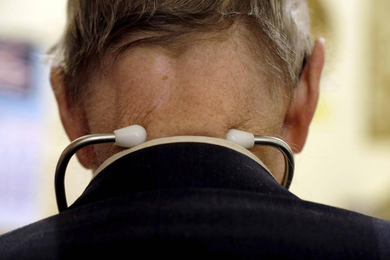 A doctor wears a stethoscope around his neck as he tends to patients in his office in Illinois on Tuesday, Oct. 30, 2012. The College of Physicians and Surgeons of British Columbia says it has suspended a doctor from practising while it completes an investigation into allegations that he sidestepped COVID-19 public health orders. THE CANADIAN PRESS/AP, Jeff Roberson