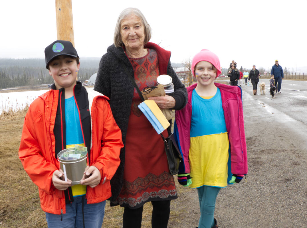Karl Lundsbye, left, Claudia Ring and Rowan Hermiston finish a lap in the Peace March for Ukraine Sunday. Ring donated $800 to the youth’s fundraiser, which collected close to $7,000 for the Ukrainian Red Cross. (Kelly Sinoski photo -100 Mile Free Press).