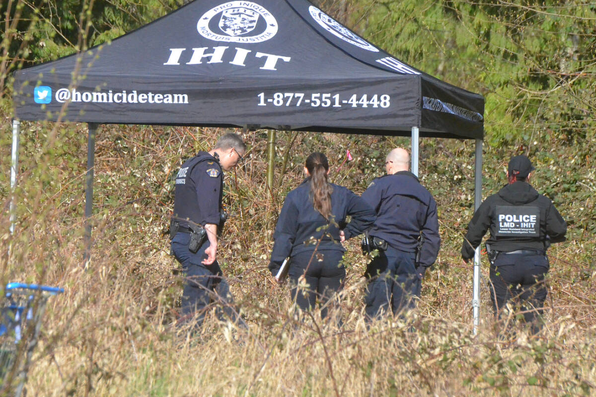 Investigators checked out an area covered by a canopy in the middle of a vacant lot on 208th Street in Willoughby. (Matthew Claxton/Langley Advance Times)