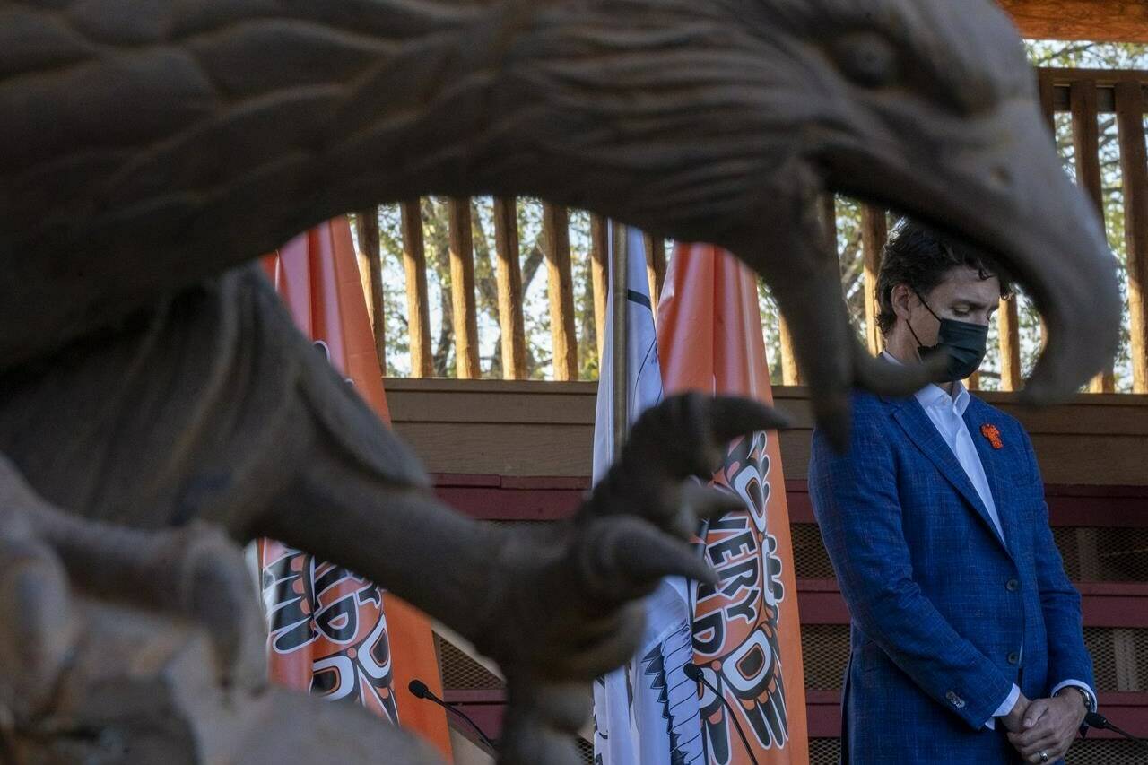 Prime Minister Justin Trudeau is framed by a eagle statue as he visits Tk’emlups te Secwepemc in Kamloops, B.C. Monday, Oct. 18, 2021. THE CANADIAN PRESS/Jonathan Hayward