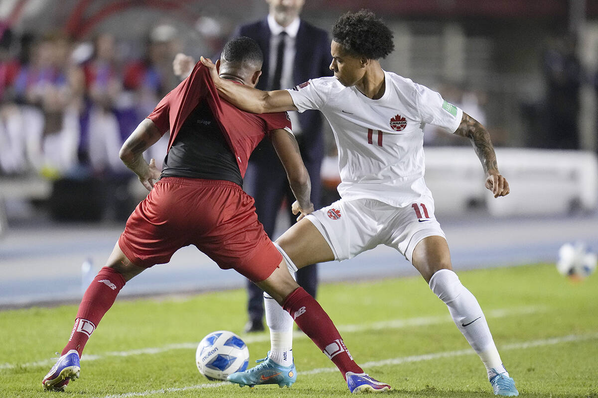Panama’s Eric Davis, left, and Canada’s Tajon Buchanan battle for the ball during a qualifying soccer match for the FIFA World Cup Qatar 2022 in Panama City, Panama, Wednesday, March 30, 2022. (AP Photo/Arnulfo Franco)