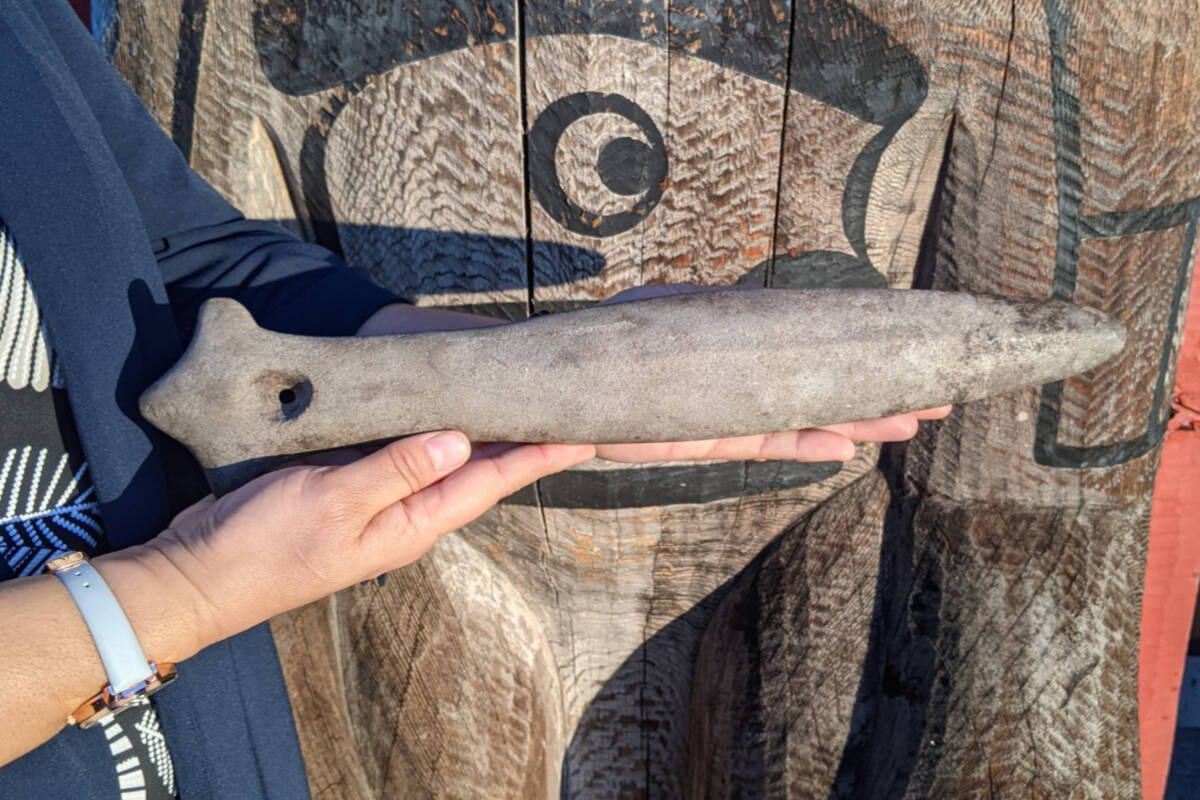 The artifact appears to be a war club. Photo, K’ómoks First Nation