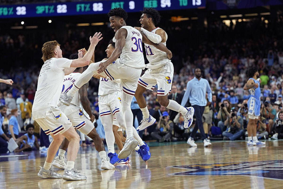 Kansas guard Ochai Agbaji celebrates with teammates after their win against North Carolina during a college basketball game in the finals of the Men’s Final Four NCAA tournament, Monday, April 4, 2022, in New Orleans. (AP Photo/David J. Phillip)