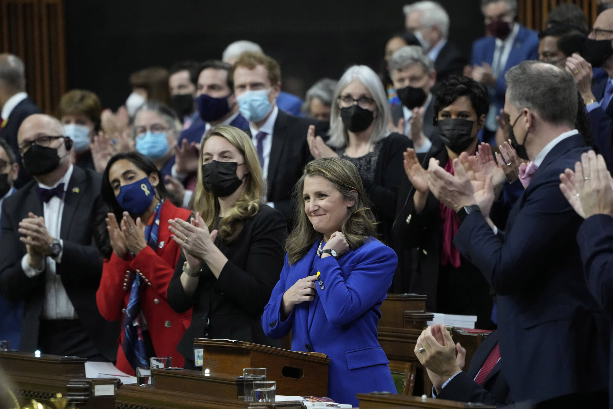 Finance Minister Chrystia Freeland receives applause as she points to a pin she wears in support for Ukraine as she tables the federal budget in the House of Commons in Ottawa, Thursday, April 7, 2022. THE CANADIAN PRESS/Adrian Wyld