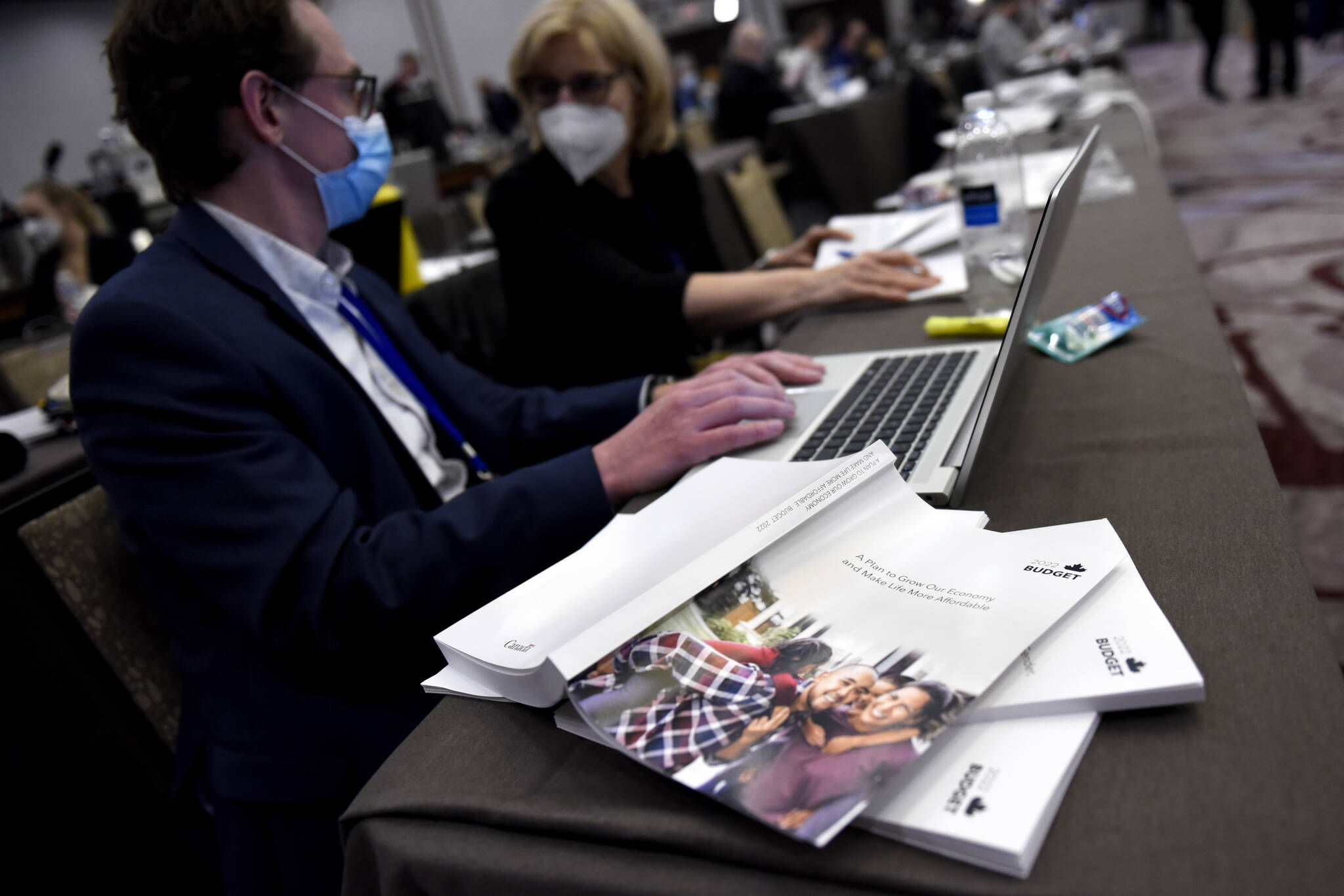 Copies of the 2022 federal budget are seen on a table as journalists work in the media lockup, ahead of the tabling of the federal budget, in Ottawa, on Thursday, April 7, 2022. THE CANADIAN PRESS/Justin Tang
