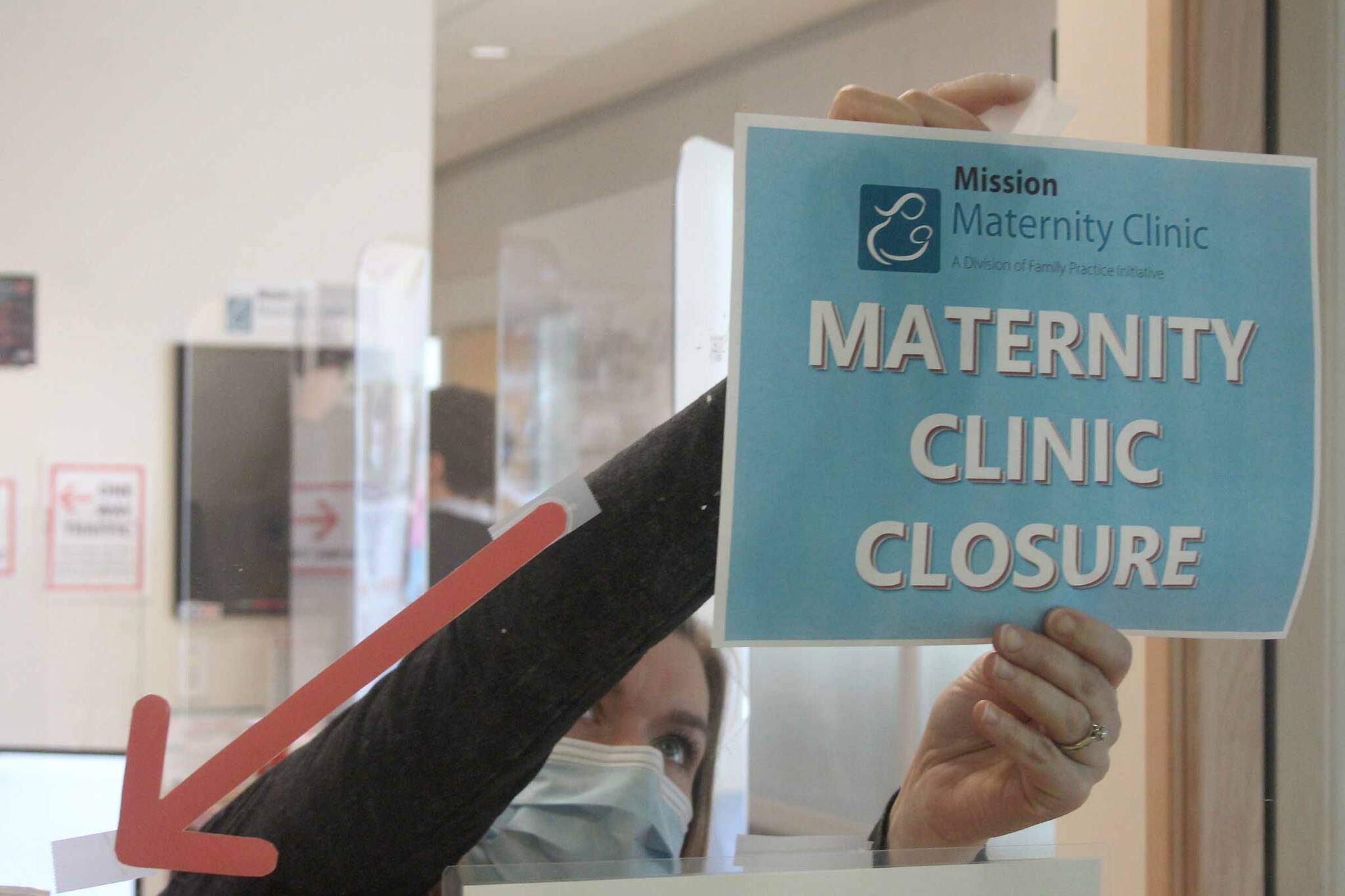 Staff at the Mission Maternity Clinic post a sign to the window announcing the closure. Patrick Penner / Mission Record