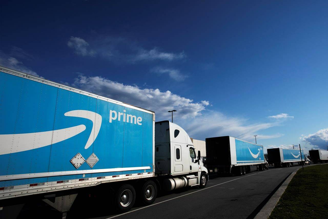 Amazon tractor trailers line up outside the Amazon Fulfillment Center in the Staten Island borough of New York. Amazon says it will raise the price of its Prime membership in Canada, effective immediately. Monthly memberships will increase by $2 to $9.99 per month, while annual memberships will rise $20 to $99. (AP Photo/Mark Lennihan, File)