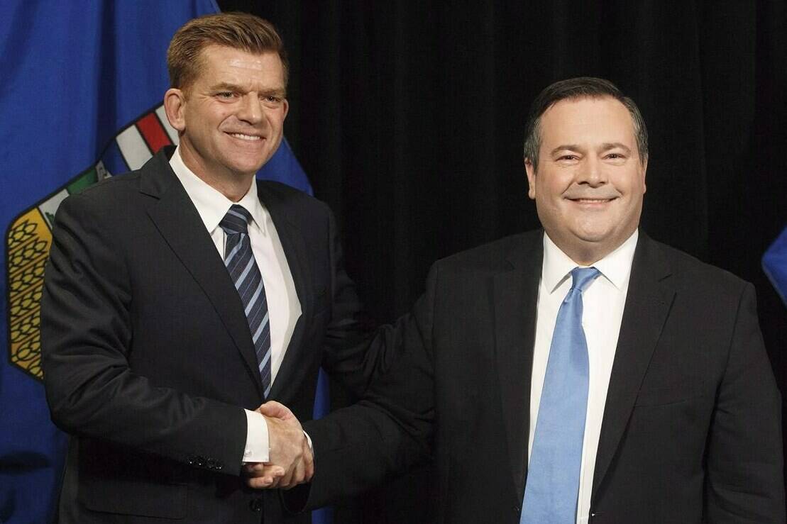 Alberta Wildrose leader Brian Jean and Alberta PC leader Jason Kenney shake hands after announcing a unity deal between the two in Edmonton on May 18, 2017. THE CANADIAN PRESS/Jason Franson